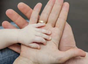 Family together. Father and mother holding child's hand